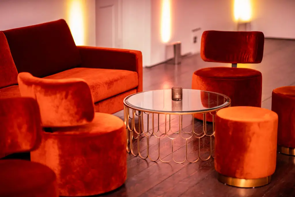 Velvet red chairs and a glass table